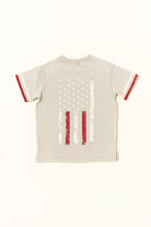 Beige t-shirt with American flag design on a white background by rad toddler
