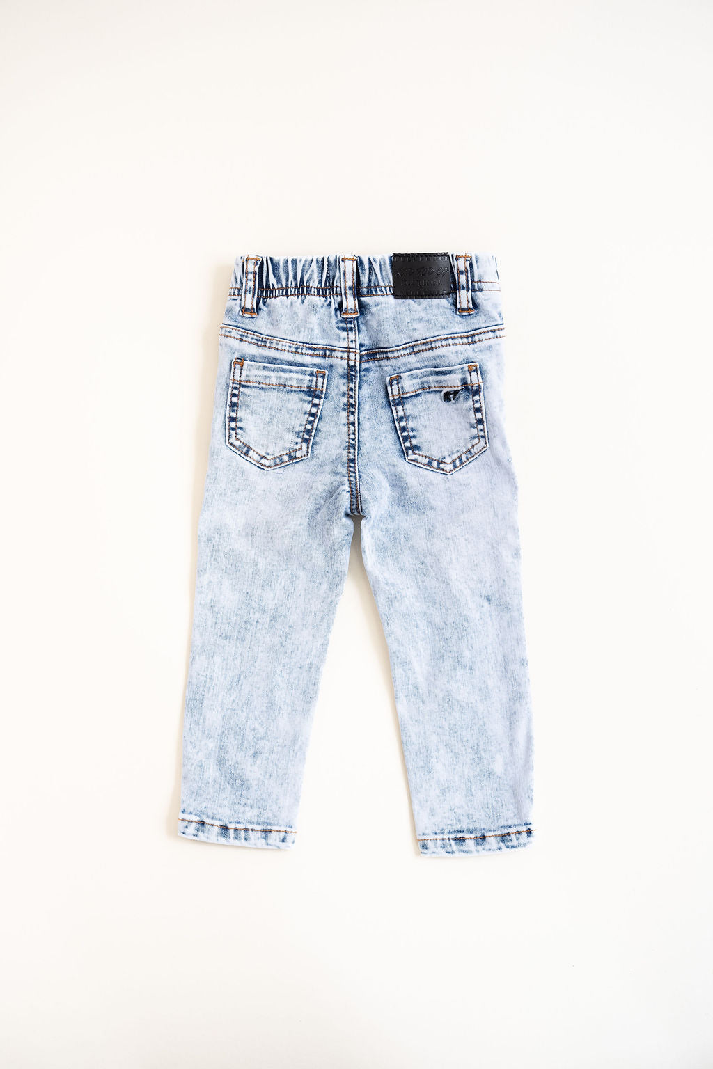 Light blue distressed jeans on a white background