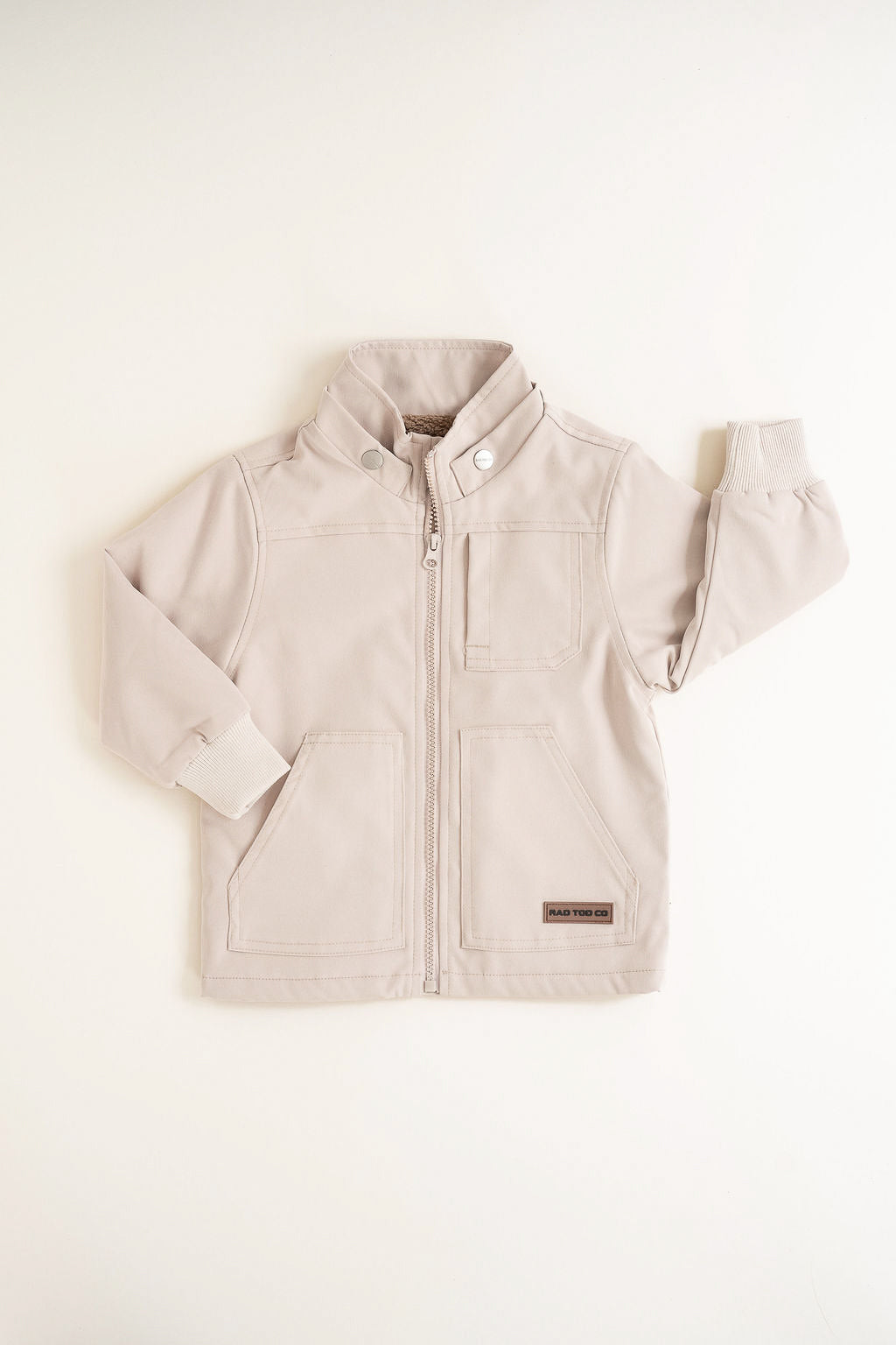 Beige children's jacket on a white background
