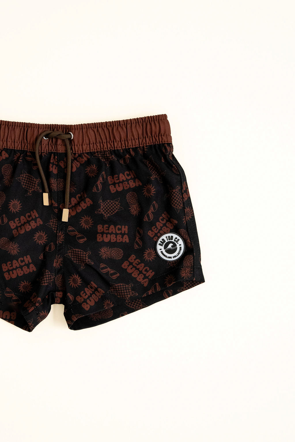 Black swim shorts with brown accents and 'Beach Bubba' branding on a white background