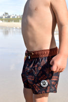 Toddler wearing Beach Bubba swim shorts in Black with above-the-knee European fit