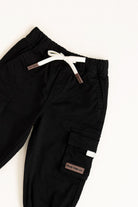 Black cargo pants with white drawstring on a white background