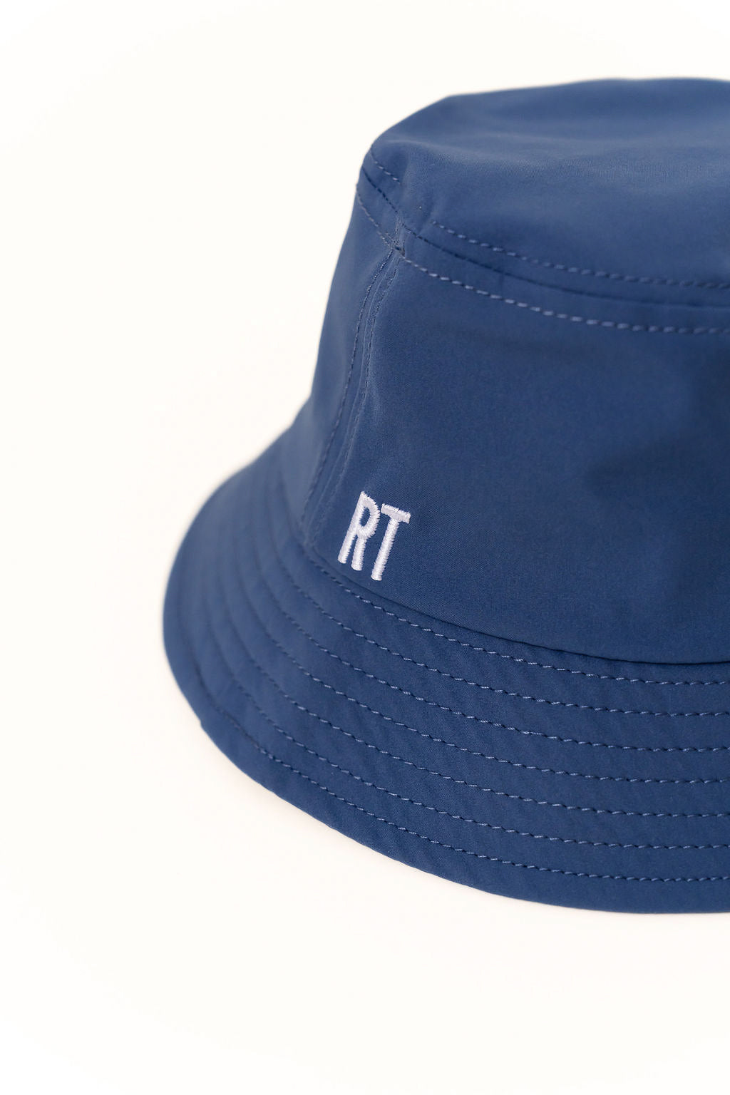 Blue bucket hat with 'RT' logo on a white background