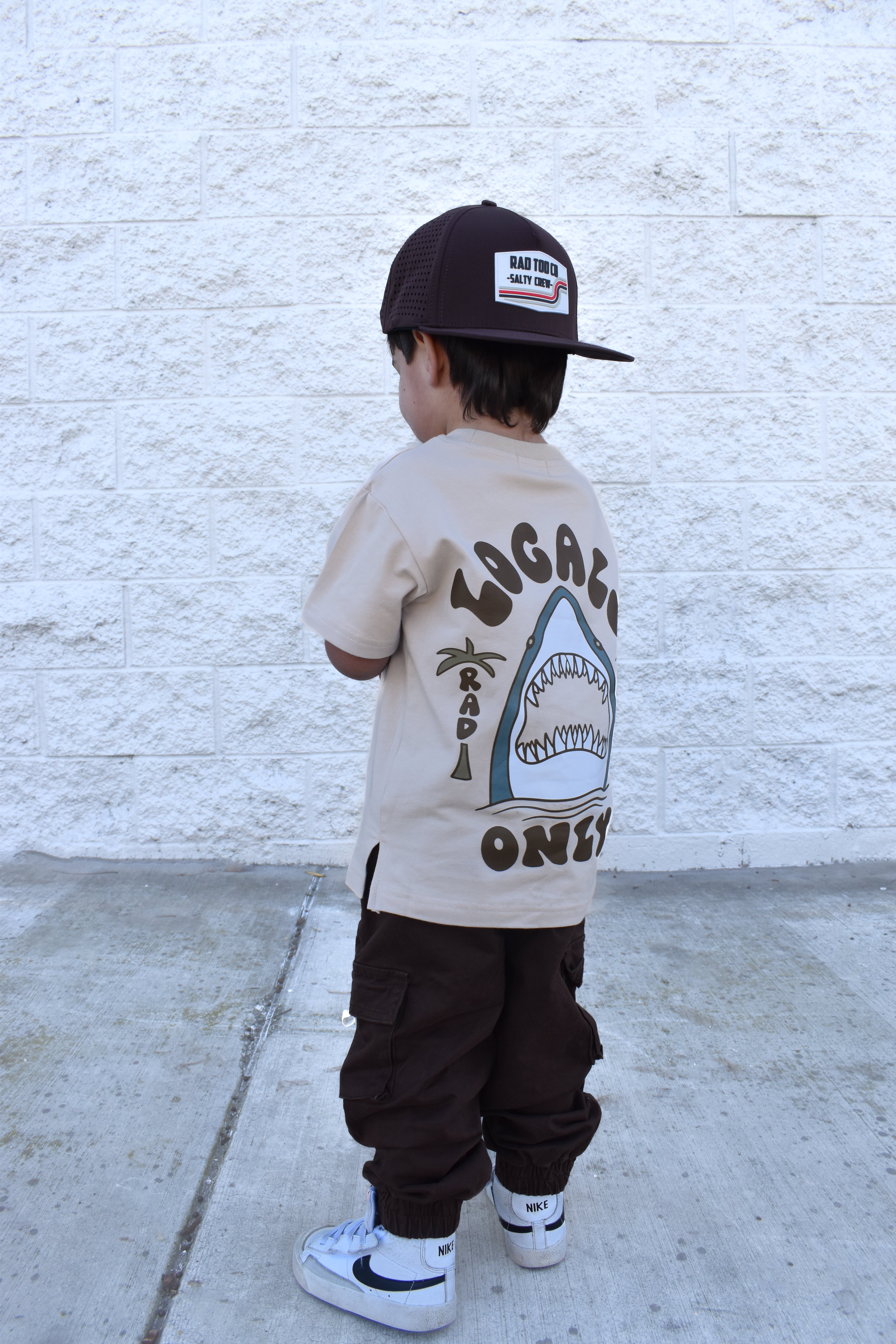 Cool kid wearing beige Locals Only shark t-shirt, everyday kids street style