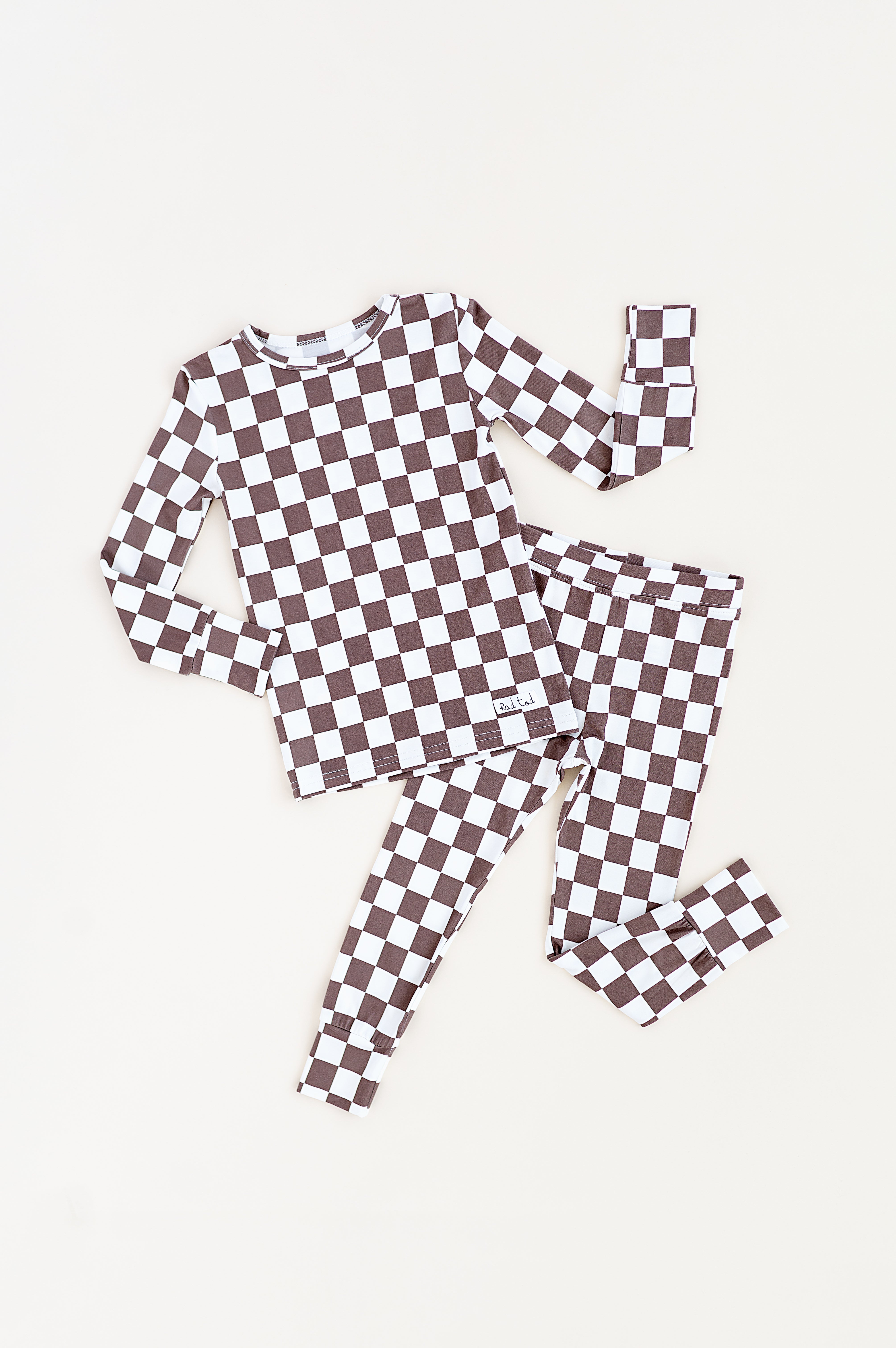 Bronze and white checkered bamboo 2-piece pajama set for toddlers, featuring a short sleeve top and elastic waistband pants by Rad Toddler.