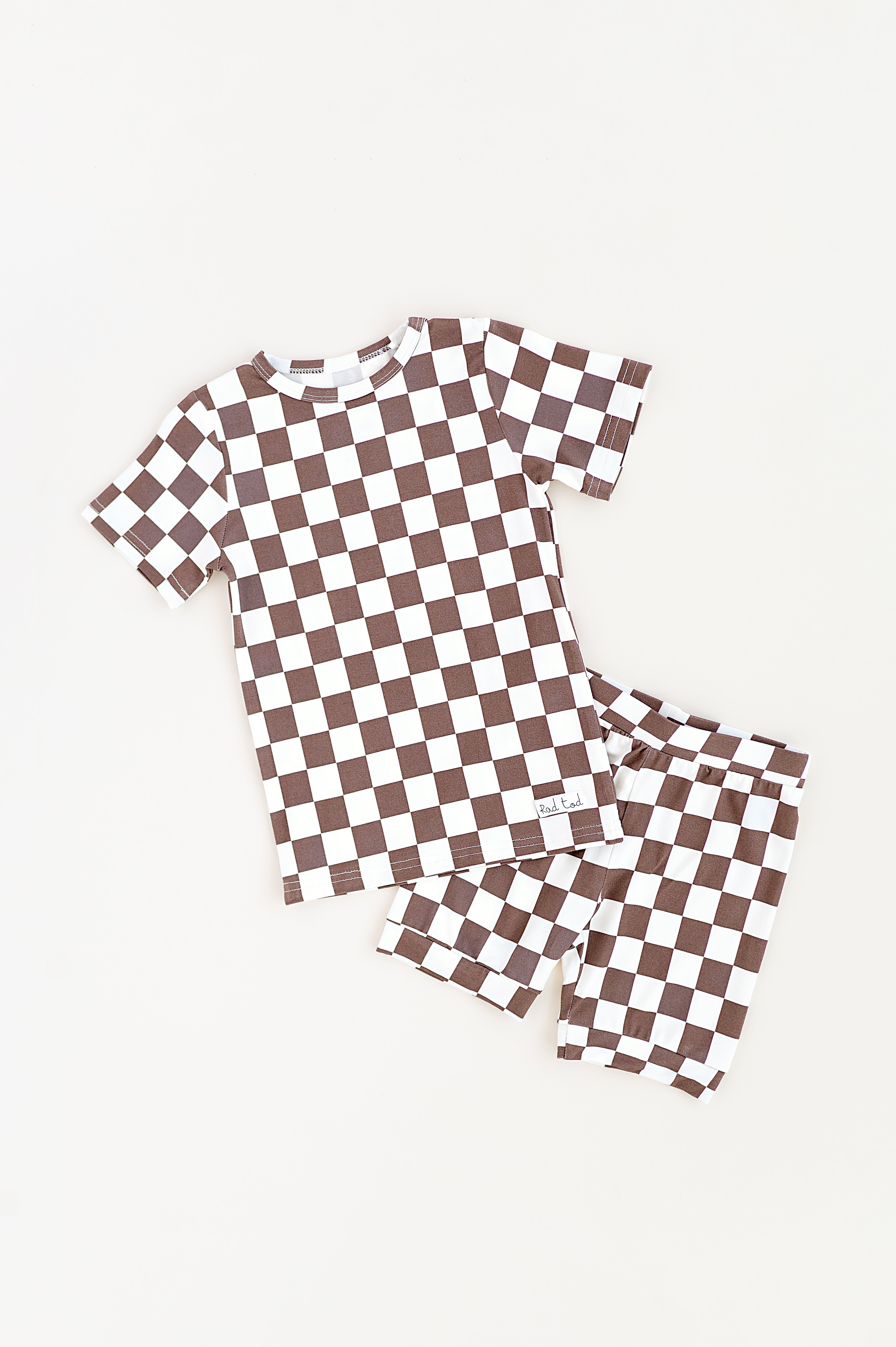 Bronze and white checkered bamboo short sleeve pajama set for toddlers, featuring soft, breathable fabric and a stretchy waistband by Rad Toddler.