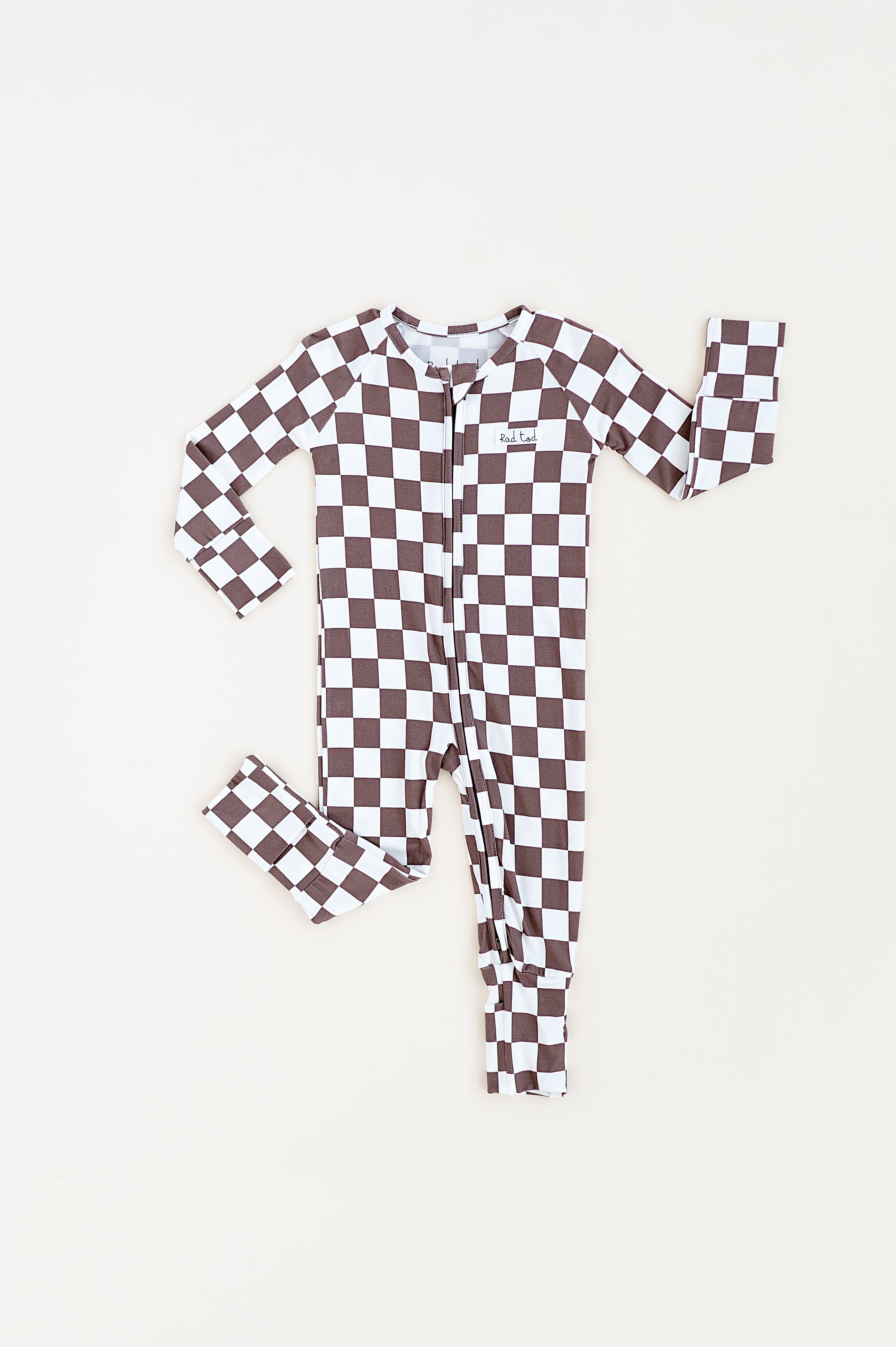 Long sleeve bronze and white checkered bamboo onesie for toddlers, featuring a two-way zipper and foldover footies by Rad Toddler.