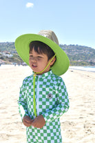 Stylish kids rashguard onesie green checker surf style and straw hat by rad toddler