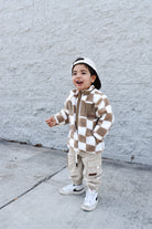 Cozy beige checker sherpa jacket styled for winter