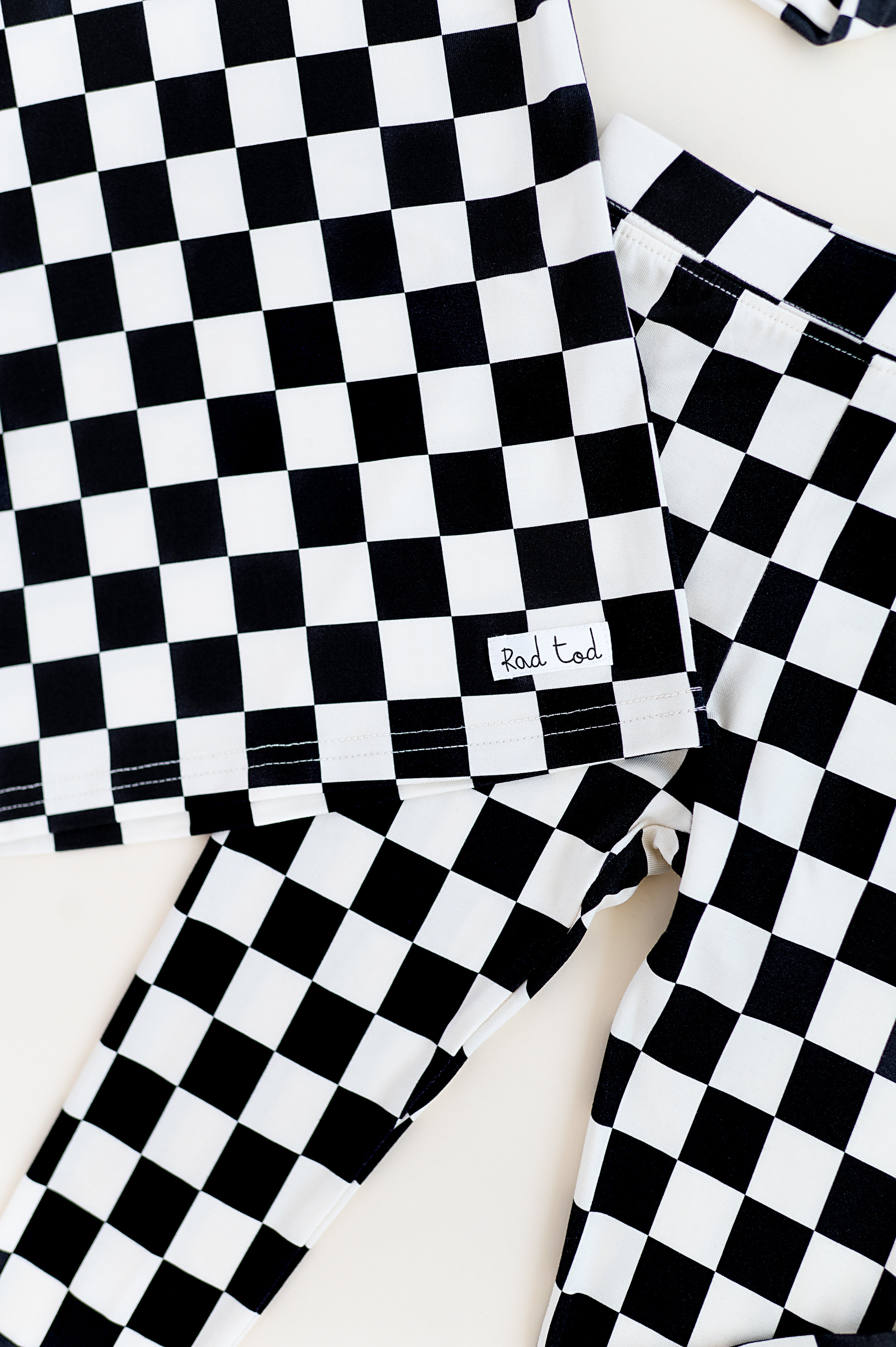 details on Black checkered 2-piece pajamas for toddlers and kids, featuring a comfy fit and elastic waistband by Rad Toddler.