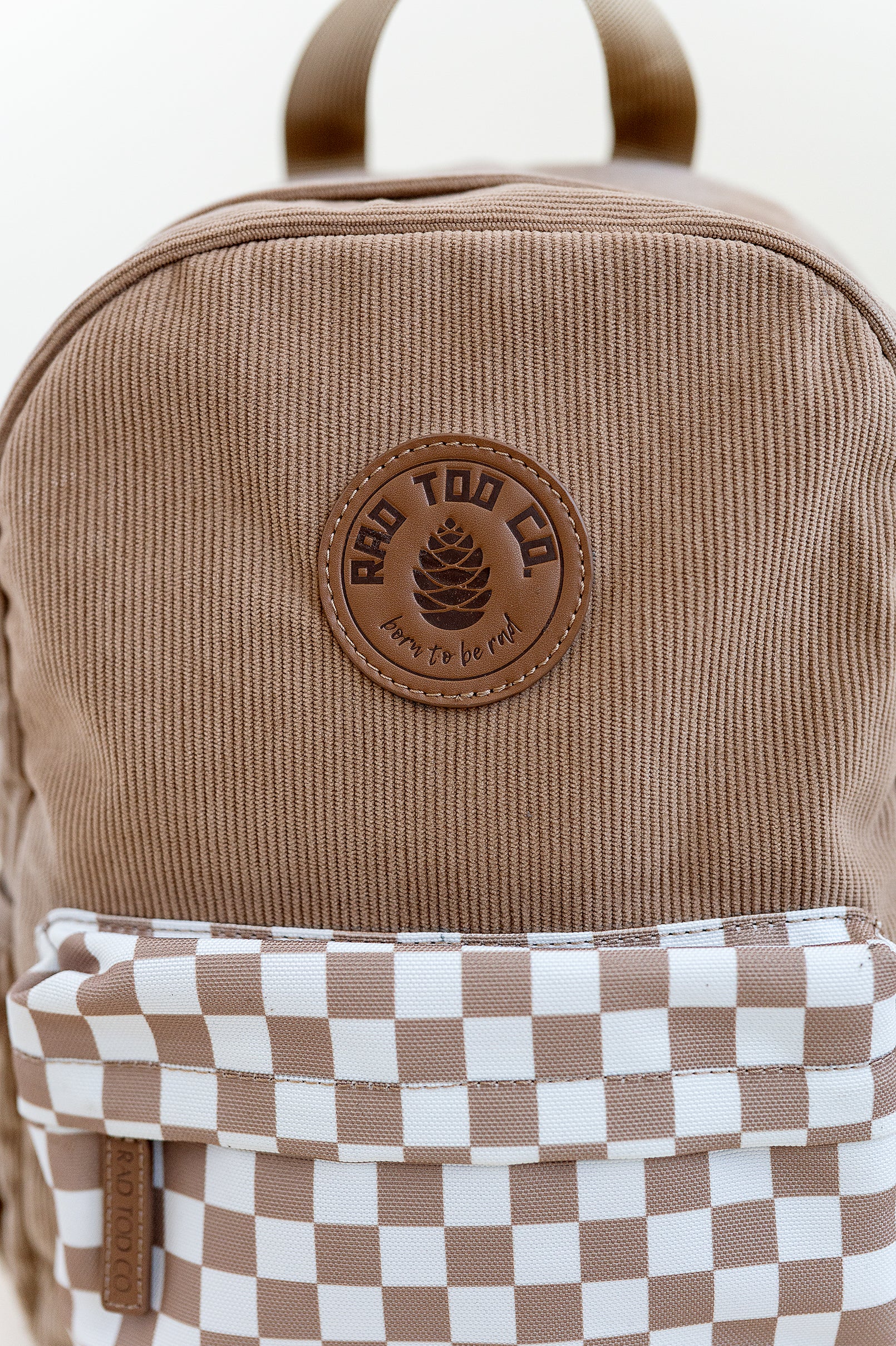 details on the dune toddler backpack with checker patter on pocket