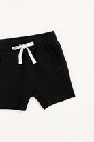 Black shorts with a white drawstring on a white background