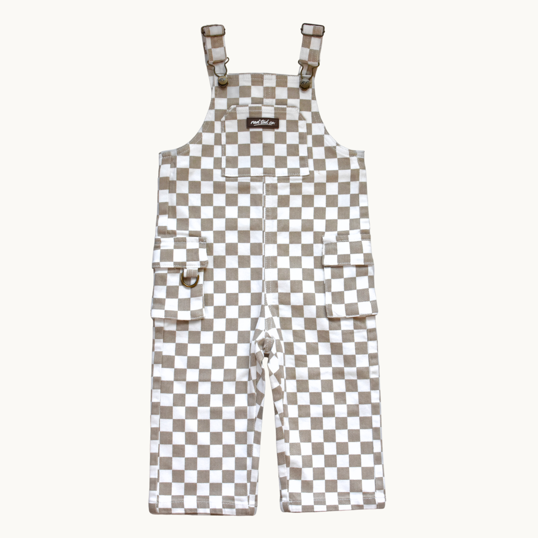 A pair of cool overalls with a beige and white checkerboard pattern, featuring adjustable shoulder straps, and two front flap pockets.