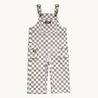 A pair of cool overalls with a beige and white checkerboard pattern, featuring adjustable shoulder straps, and two front flap pockets.