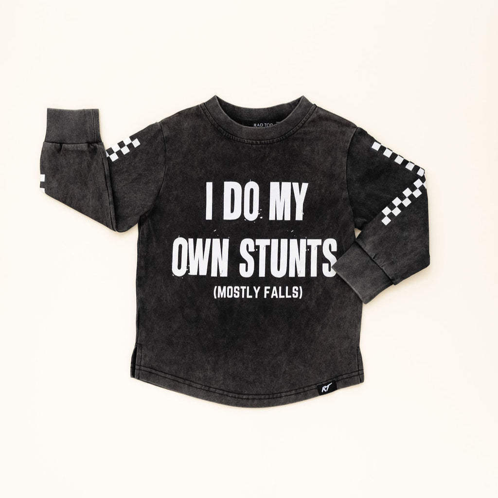I Do My Own Stunts (Mostly Falls) long sleeve in acid wash black – front vie