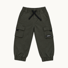 A pair of dark olive green cargo jogger pants for kids, featuring elastic waistband with a black drawstring, side cargo pockets, and elastic cuffs, shown flat on a light off-white background.