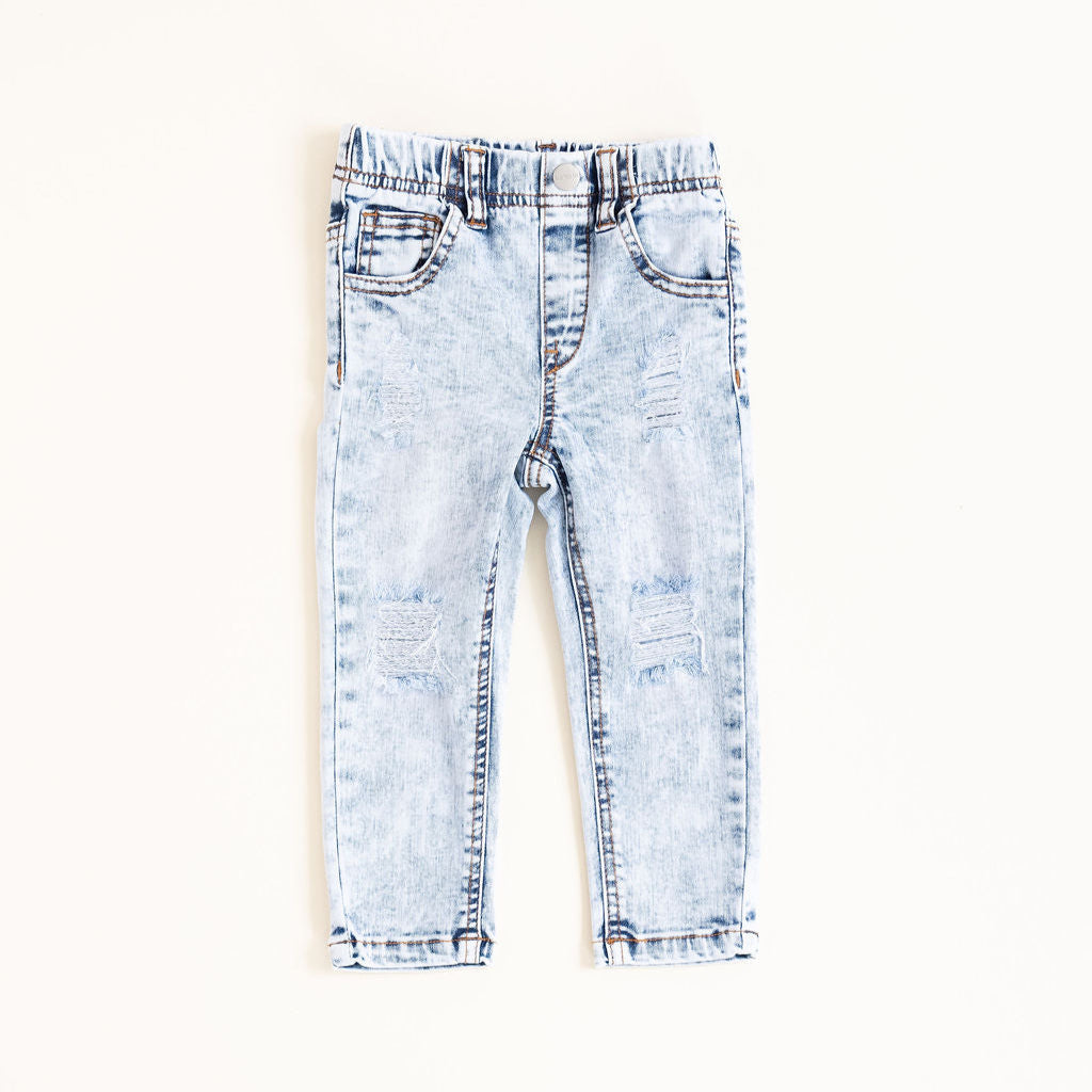 Light blue distressed jeans on a white background