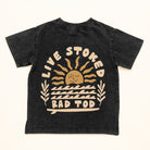 Black acid wash kids t-shirt with Live Stoked golden sun and surfboard graphic