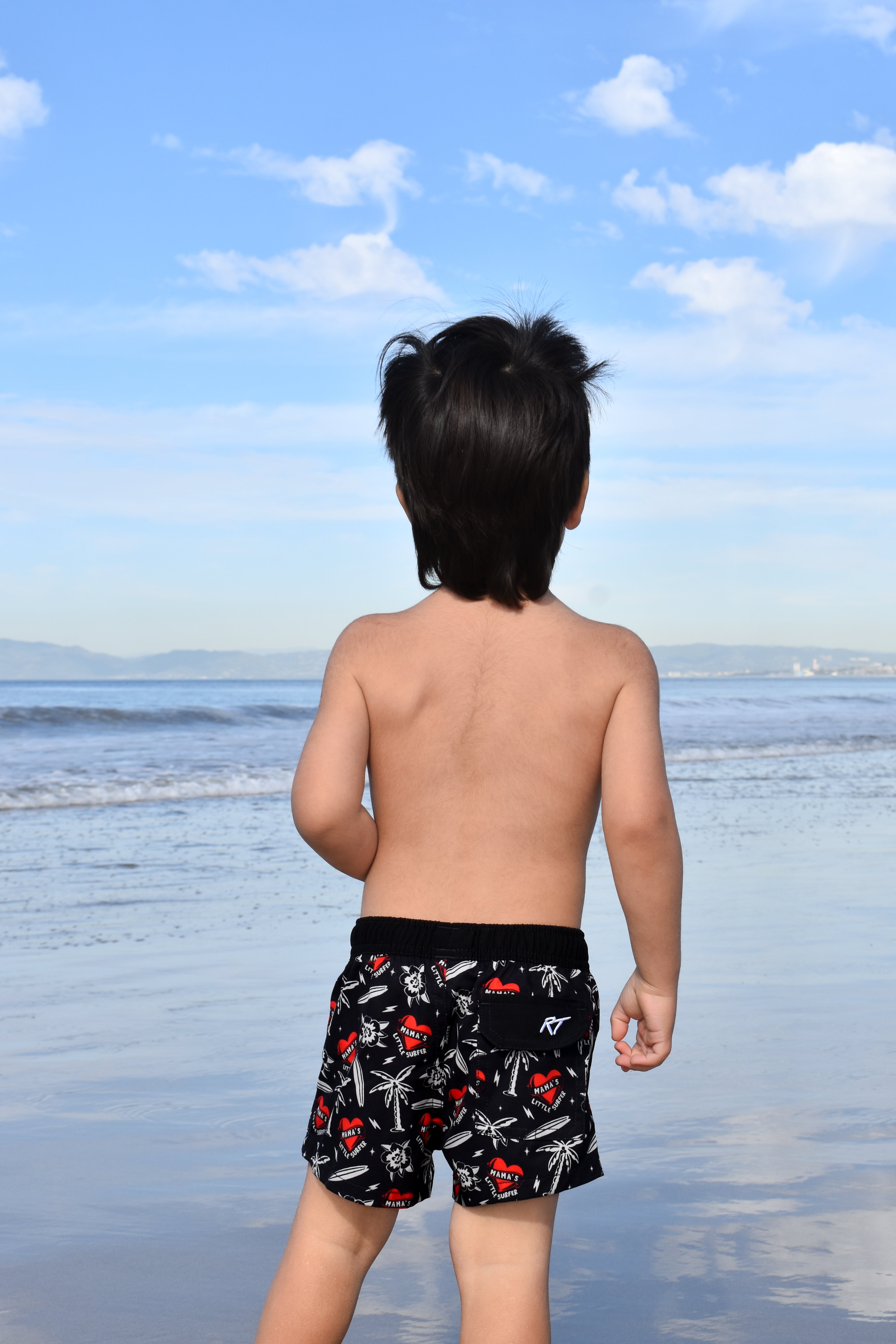 Little surfer wearing Mama’s Little Surfer Swimmie, mom-approved summer outfit
