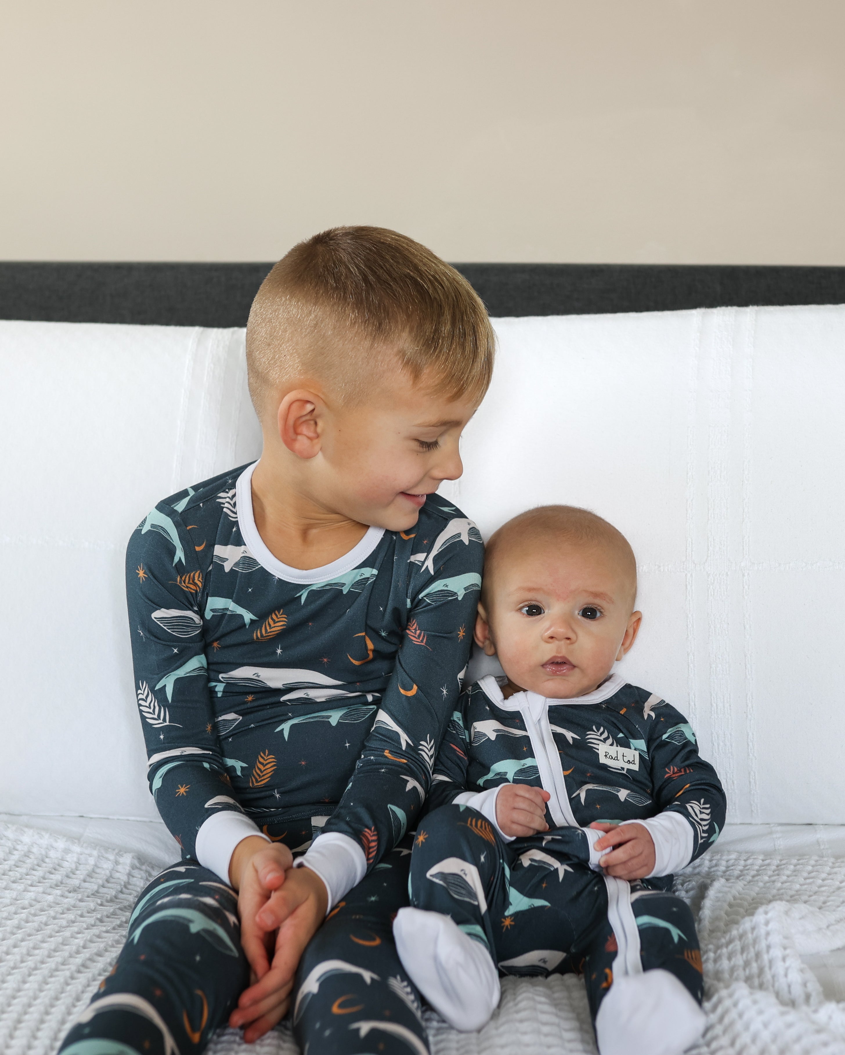 matching brothers wearing Luna Whale Bamboo Onesie featuring soft, breathable fabric, hypoallergenic properties, and a cute whale design for ultimate comfort and style