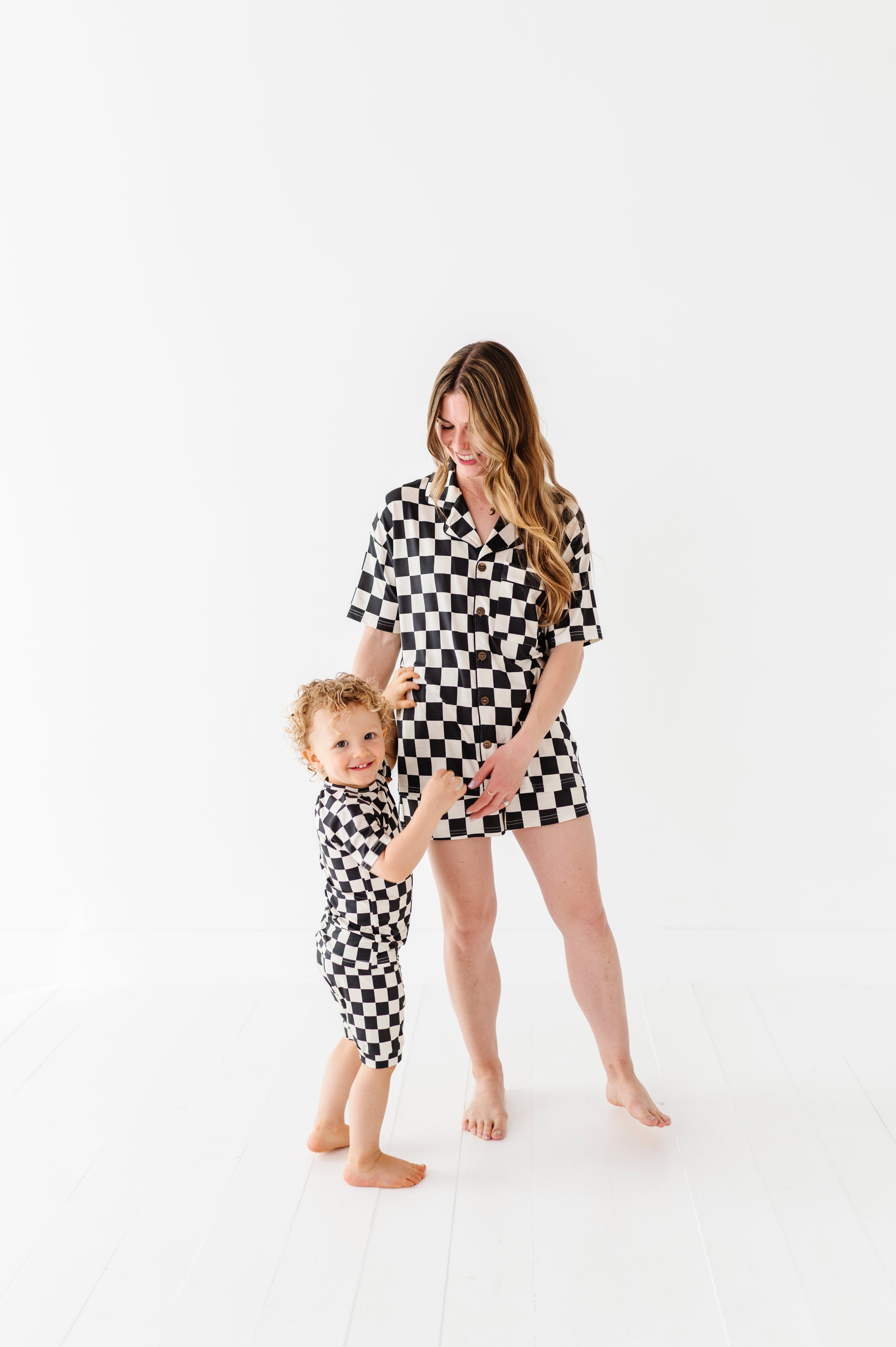 cute pic of mom and baby wearing Black and white checkered bamboo short sleeve pajama set for women, featuring soft, breathable fabric and a relaxed fit by Rad Toddler.