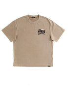 A beige short-sleeve crewneck t-shirt with a black graphic text print on the left chest reading 'MORNING NEEDS COFFEE' with a coffee cup icon, displayed flat against a white background.