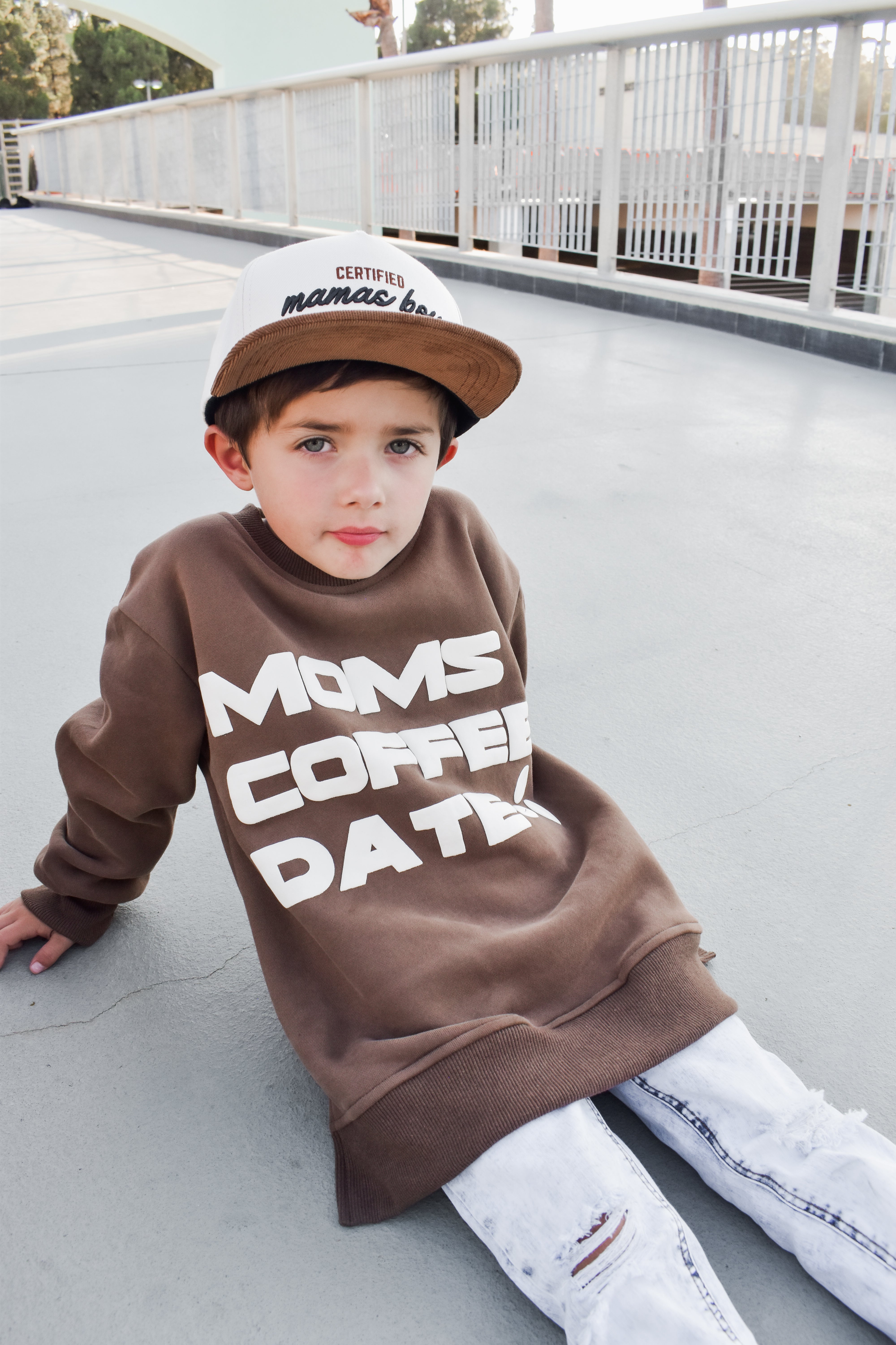 boy wearing coffee-brown “Mom’s Coffee Date” crewneck with bold off-white lettering, slightly oversized fit.