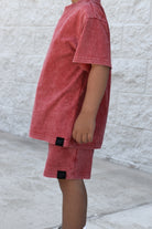 Kids muted red stone wash shorts and tee with vintage washed fabric, elastic waistband, and relaxed everyday fit for comfortable summer wear.