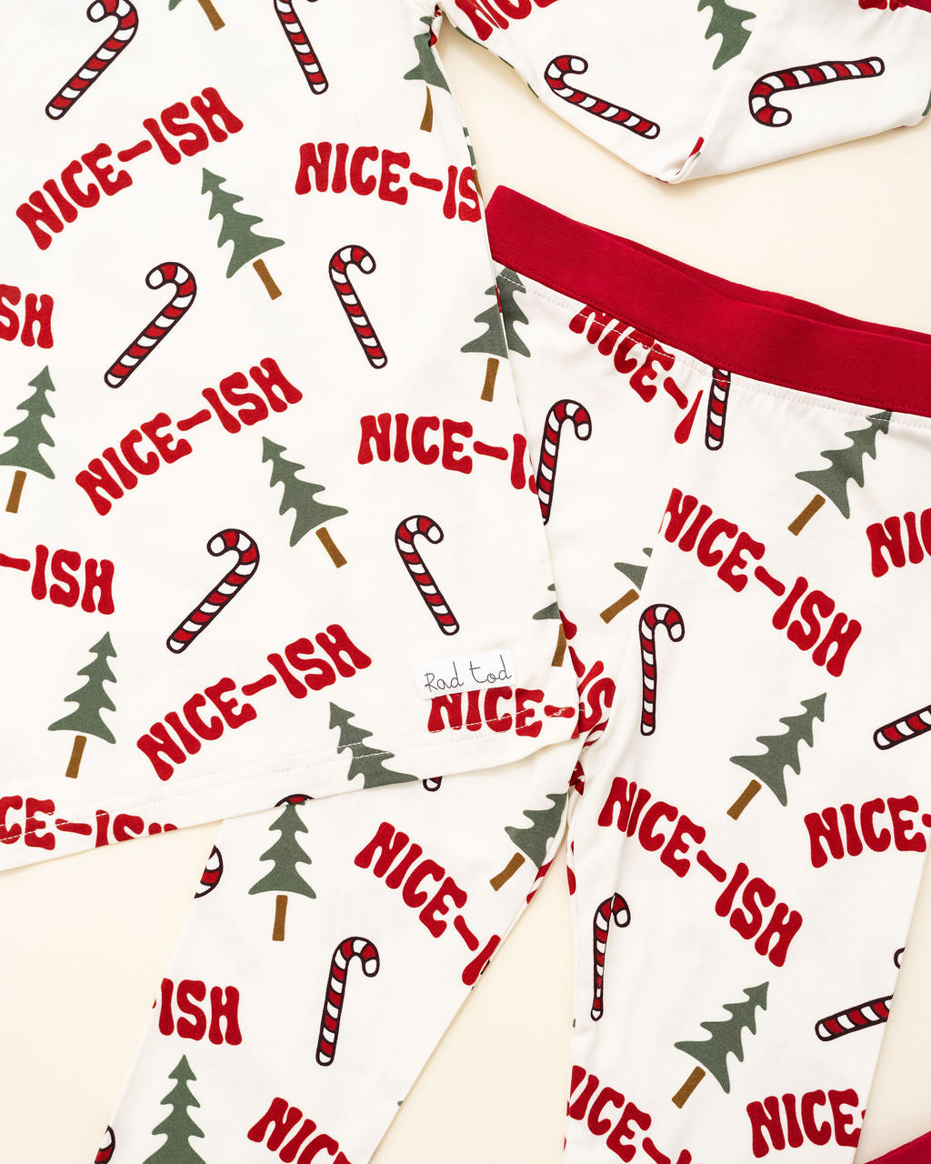 Christmas-themed fabric with candy canes, trees, and 'NICE-ISH' text on a white background.