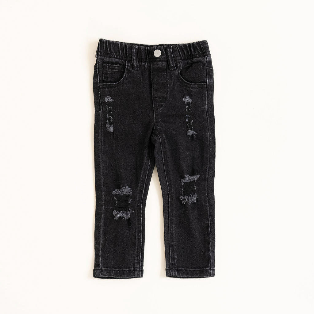 Black distressed jeans on a white background