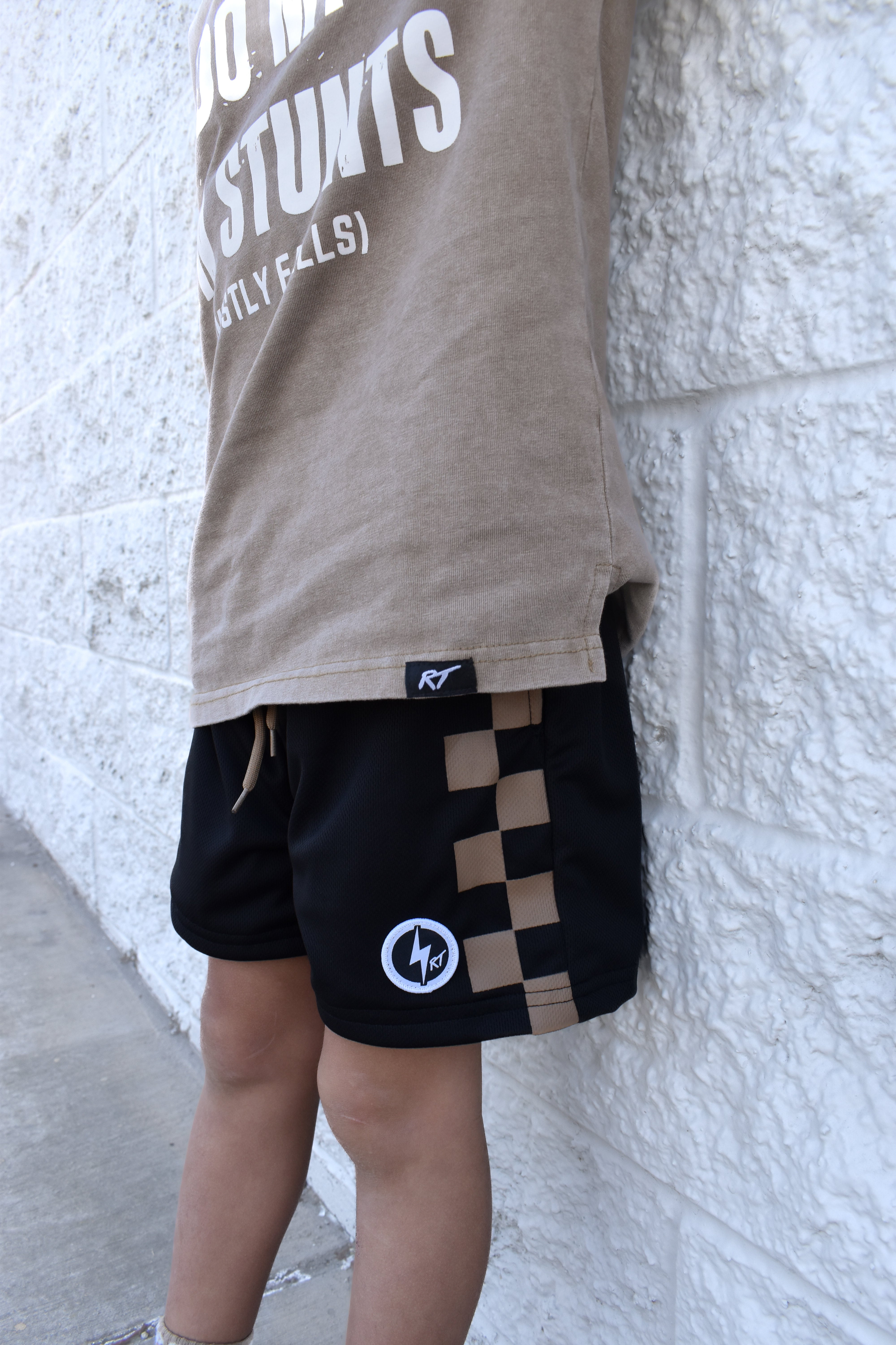 Black and sand check shorts with relaxed fit, lightweight polyester fabric, and everyday streetwear style