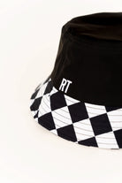Black bucket hat with checkered brim and 'RT' logo on a white background