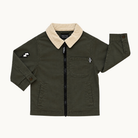 An olive green children's jacket by RAD TOD, featuring a beige sherpa collar, a black front zipper, a chest pocket with a checkered accent, and a sleeve patch, shown flat on a light cream background.
