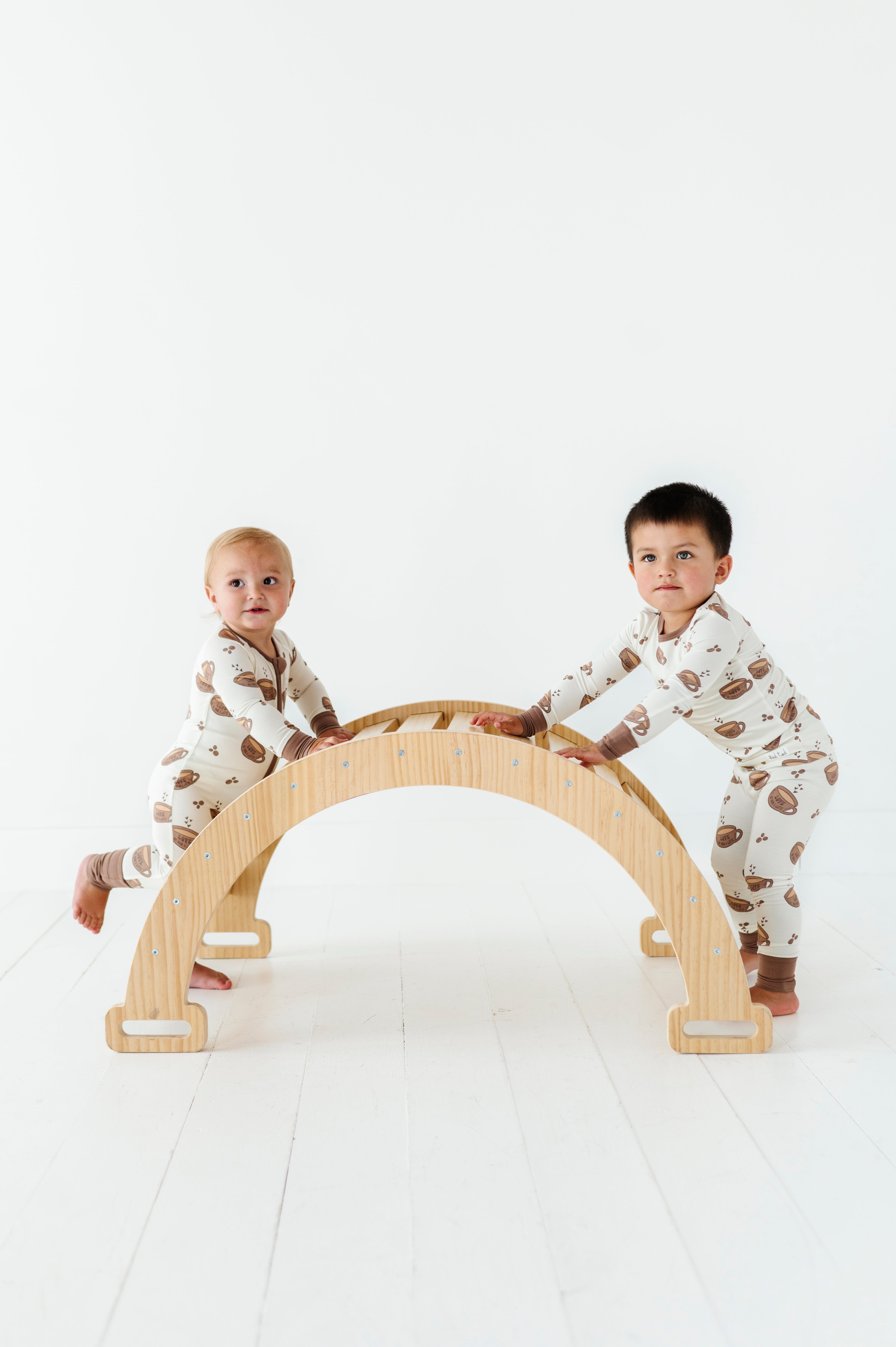 2 boys playing in the Love My Mom Latte Bamboo Pajamas featuring soft, breathable fabric and a playful design for ultimate comfort and style at bedtime