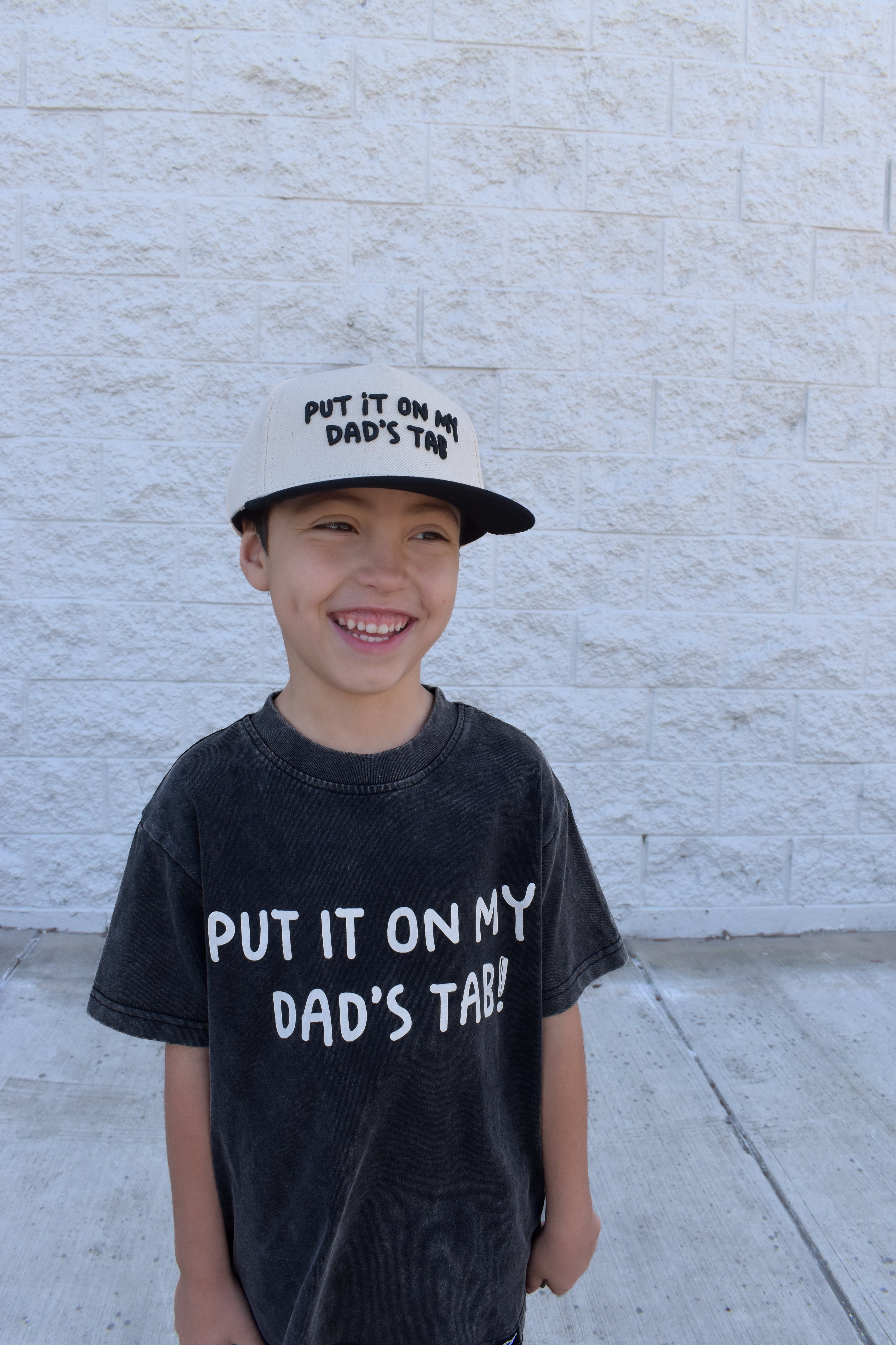 Acid wash black toddler shirt with Put It On My Dad’s Tab design