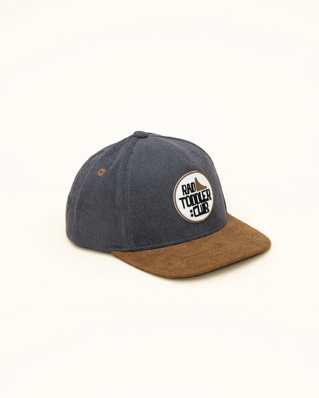Side view of gray and brown RAD TODDLER Skate Club snapback showing embroidered patch detail.