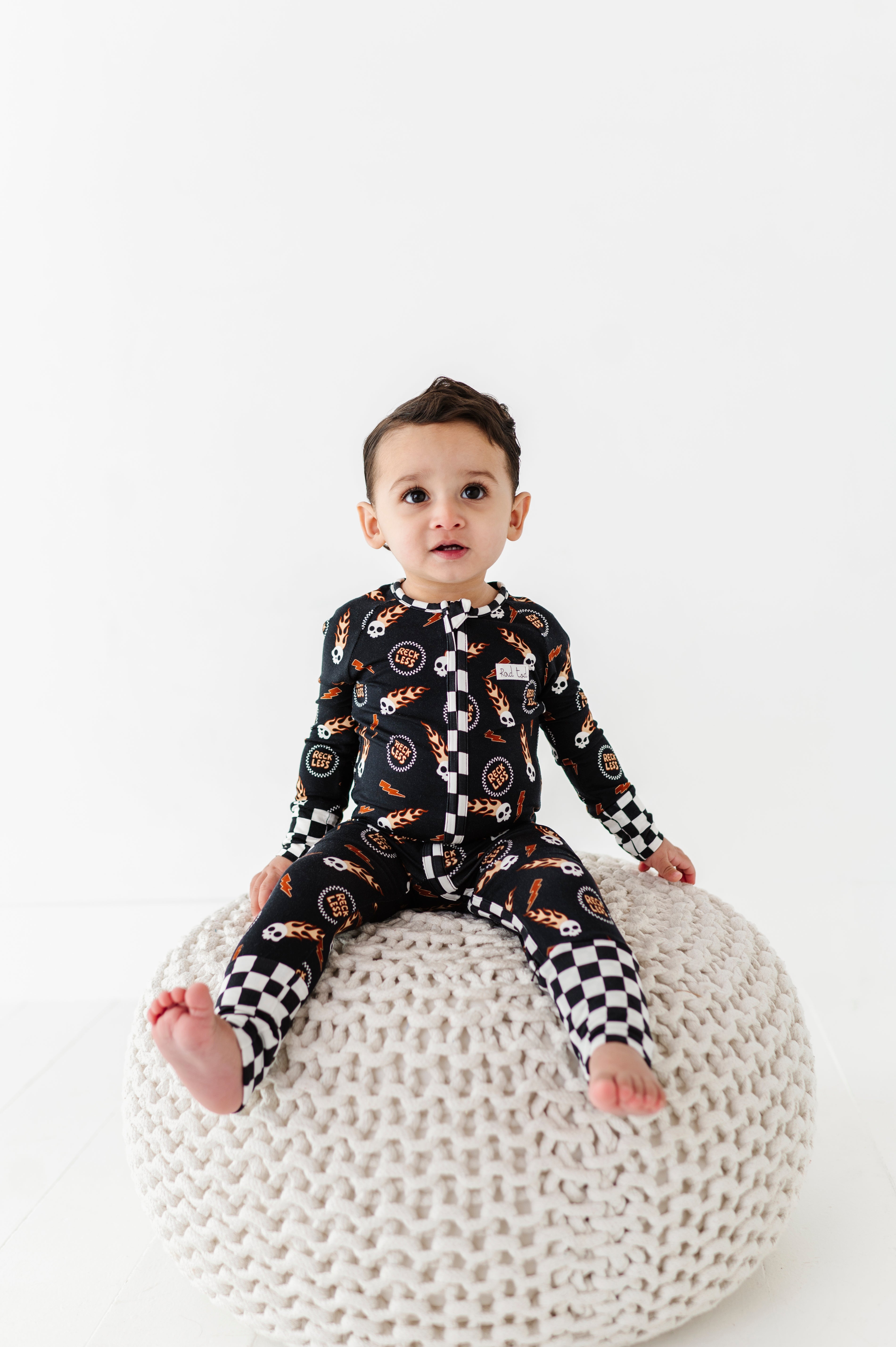 Reckless-themed bamboo baby outfit with zipper and fold-over footies