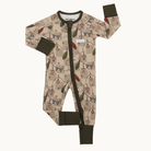 A baby's long-sleeve footed sleeper with an allover holiday string lights pattern on a beige and brown checkered background, featuring dark olive green trim on the cuffs, collar, and zipper.