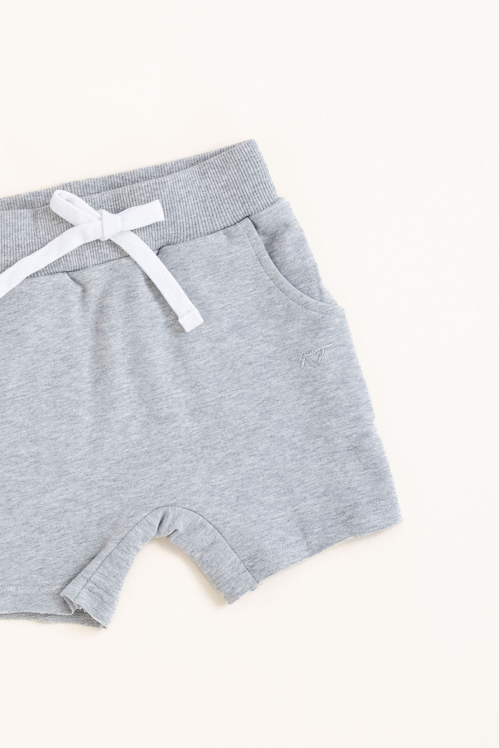 Flat lay of gray toddler shorts from the Core Collection with adjustable waistband and front pockets from the side