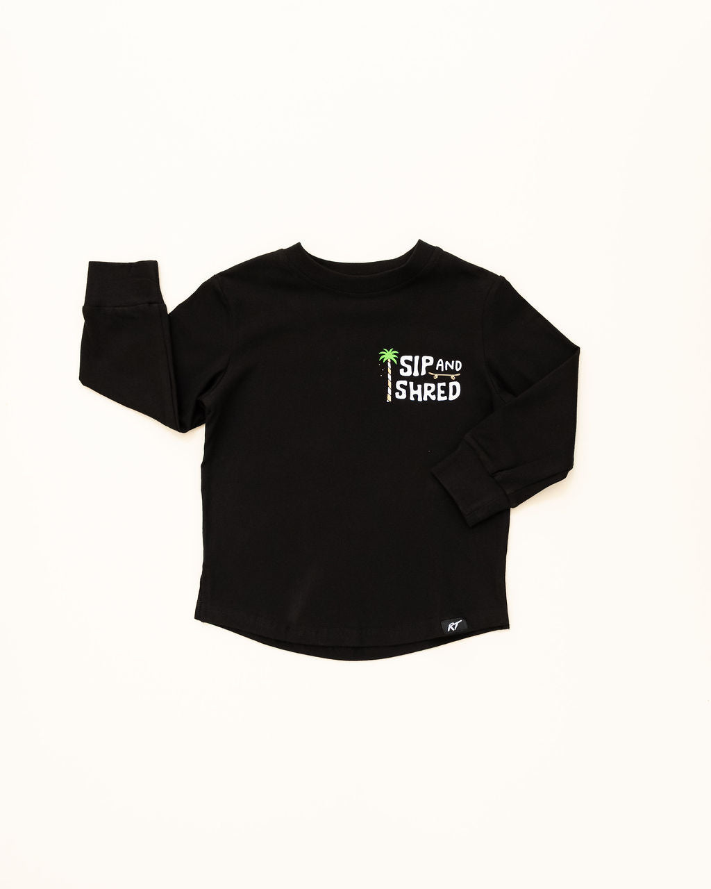 Black long-sleeve shirt with 'Sip and Shred' text on a white background