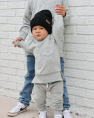 Young boy wearing gray Core Collection toddler crewneck with oversized fit, standing outdoors.