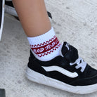 White toddler crew socks with red details and checker accents at the top in a vintage sporty style for kids.