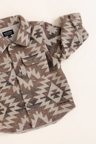 Flannel shirt with geometric pattern on a white background